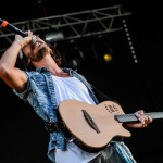 man-using-brown-and-black-electric-guitar-while-singing-167446